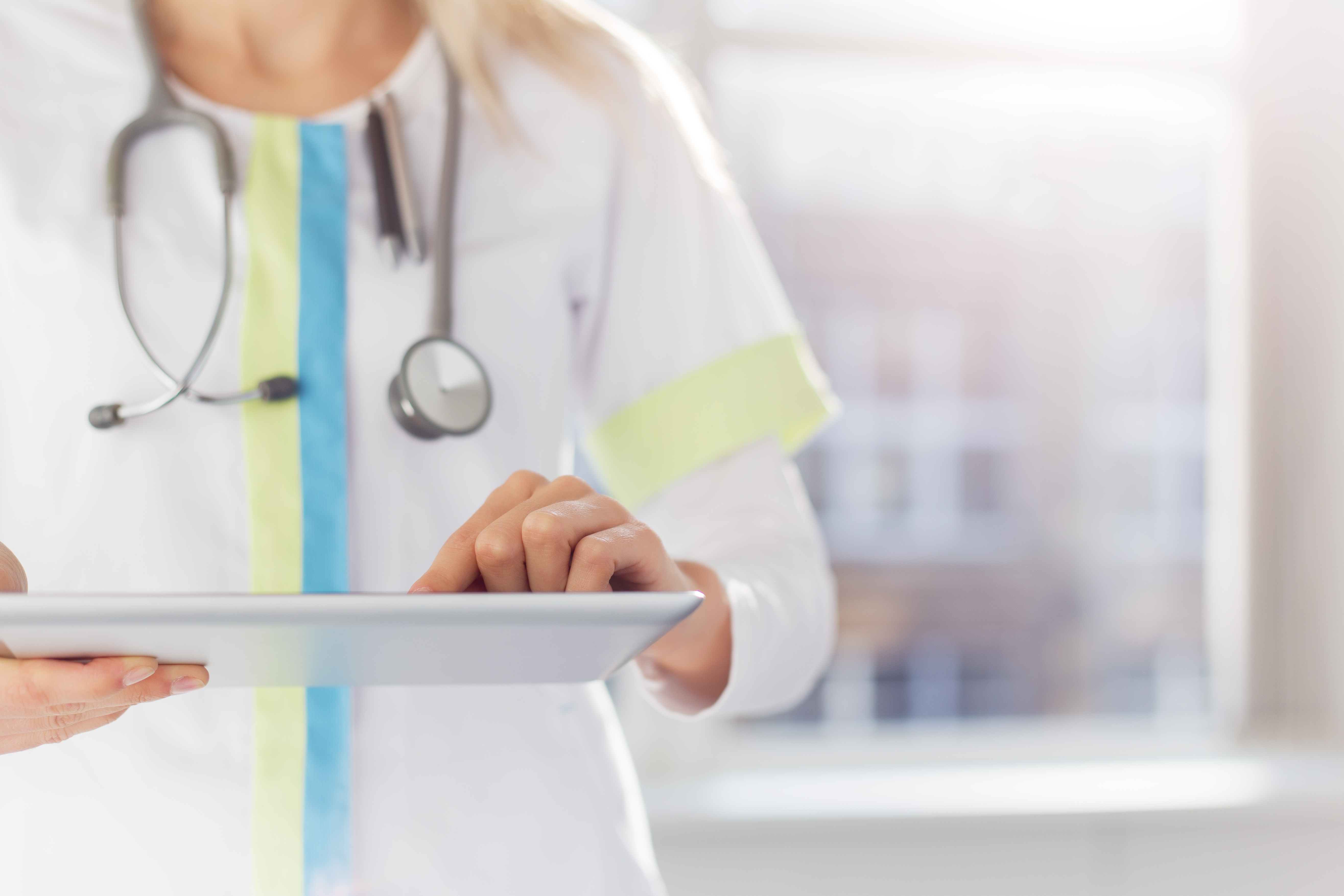 Woman doctor using tablet computer in hospital